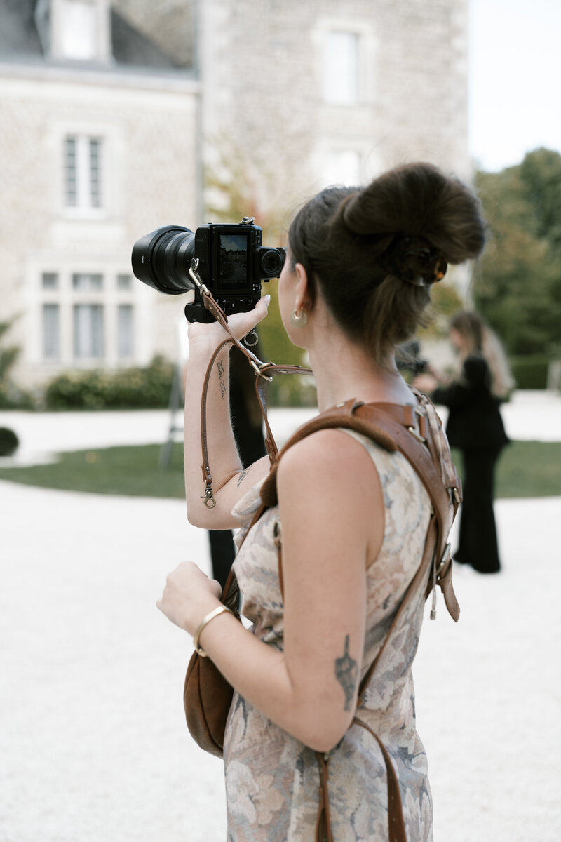 photographer at destination wedding holding up camera