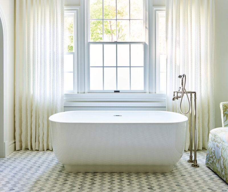 Luxury bathroom designer in Boston Milton bathrooms features mosaic tile with a freestanding tub and embroidered drapery for a custom high-end interior.