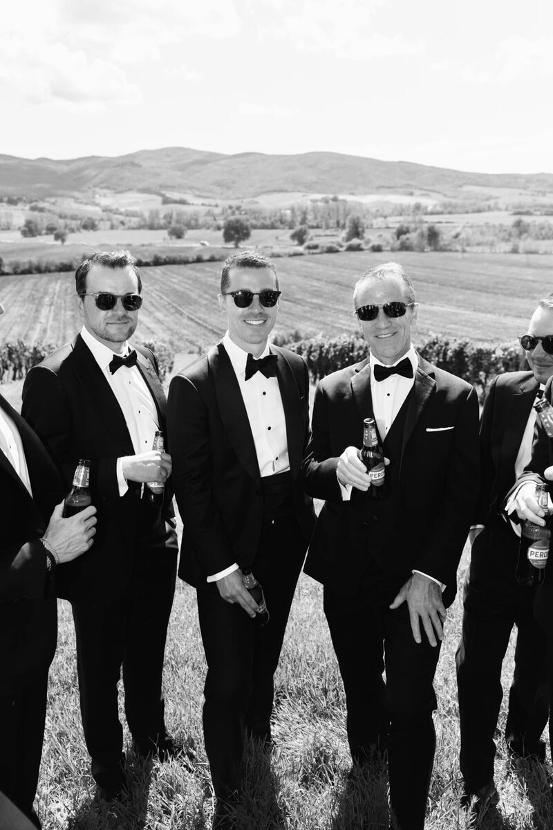 Groom and groomsmen having beer at Ombroneta Wedding in Tuscany