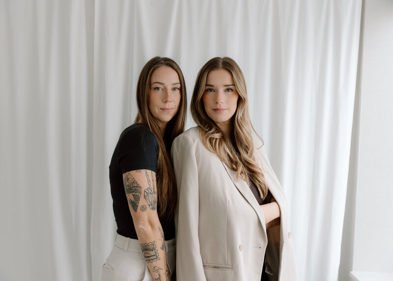 Two women standing together and smiling