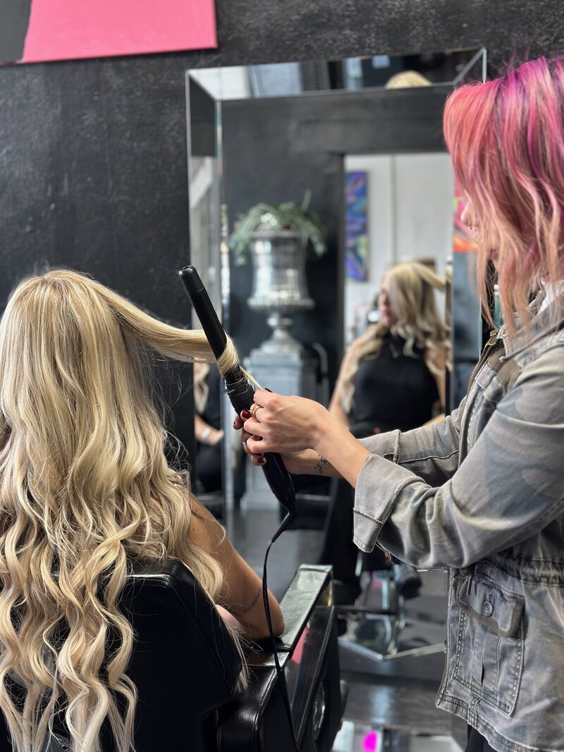Styling woman's hair with curling iron