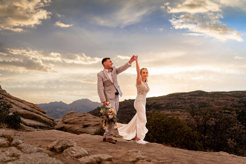 Missouri elopement photographer adventure. Wedding couple on mountain at sunset.