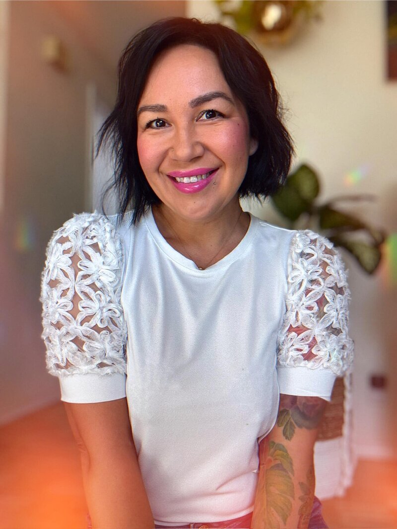 Nicole, a flower preservation artist smiles at the camera. 