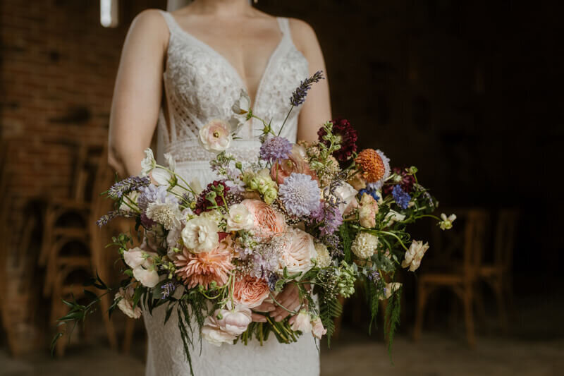 Bride holding her beautiful pastel wedding bouquet