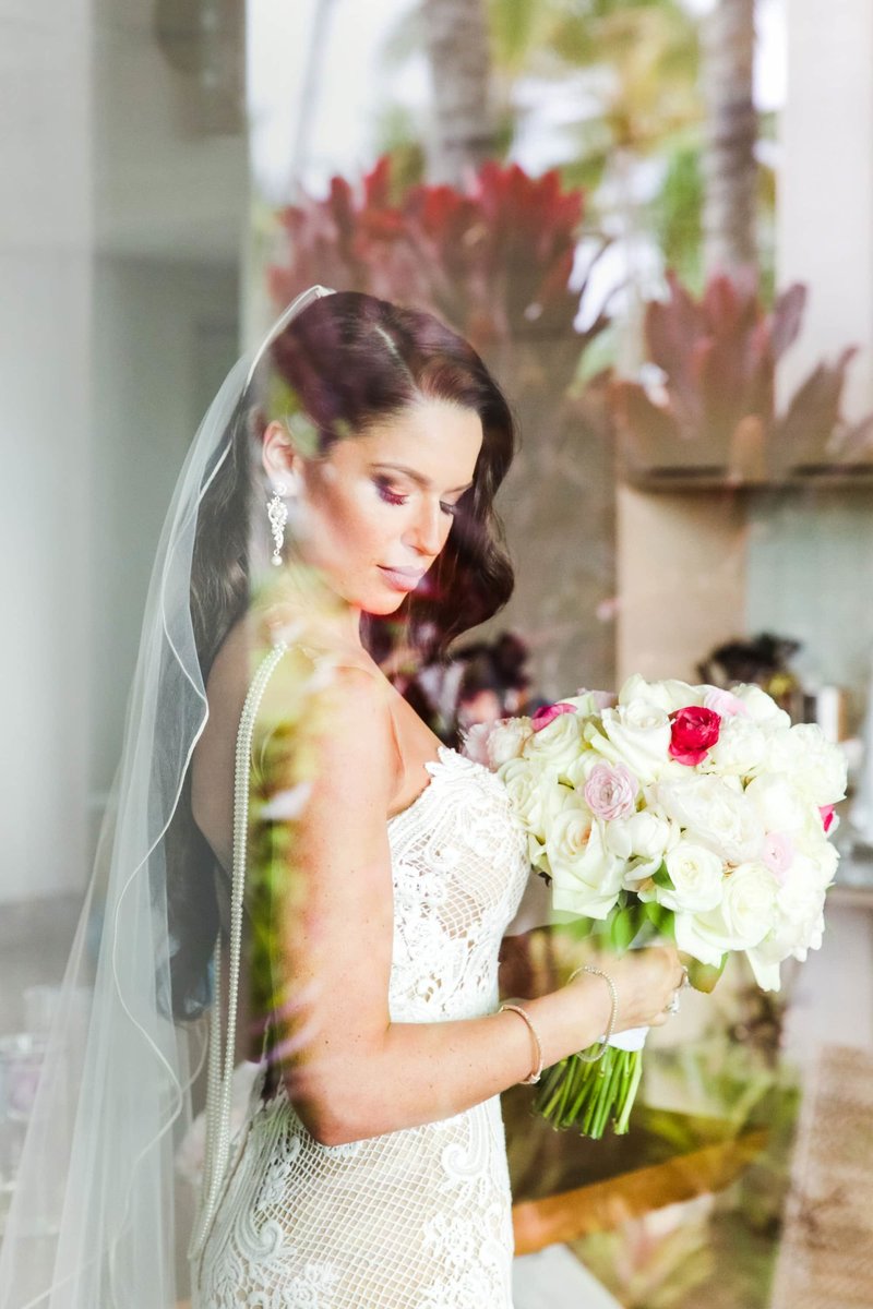 maui bridal portrait through clear glass window photographed at andaz wailea