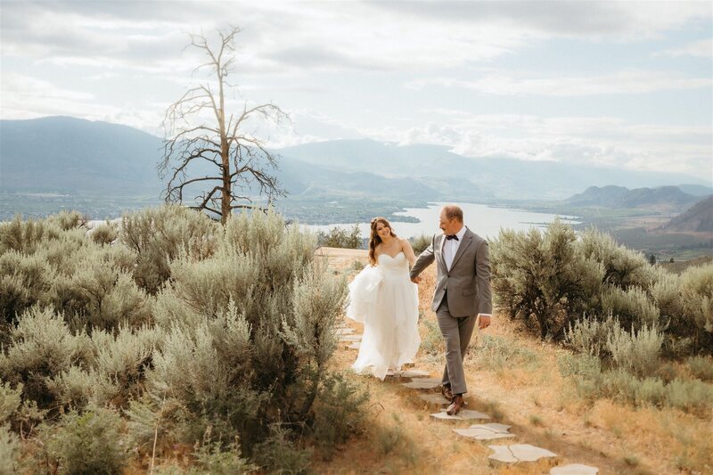 beautiful wedding portrait at the Lookout wedding venue in Osoyoos BC - photo taken by Yinet Gomez. the bride is wearing a white wedding dress and the groom a gray suit