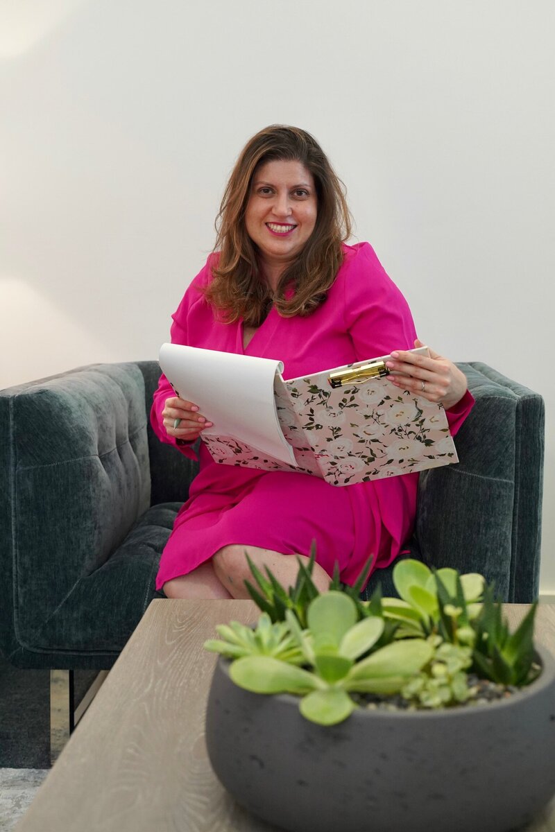 Image of Pilar smiling at the camera in her office