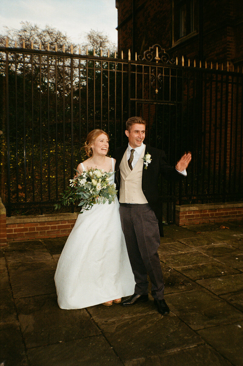 Portrait of a newlywed couple outside their luxury wedding venue shot on 35mm analogue film