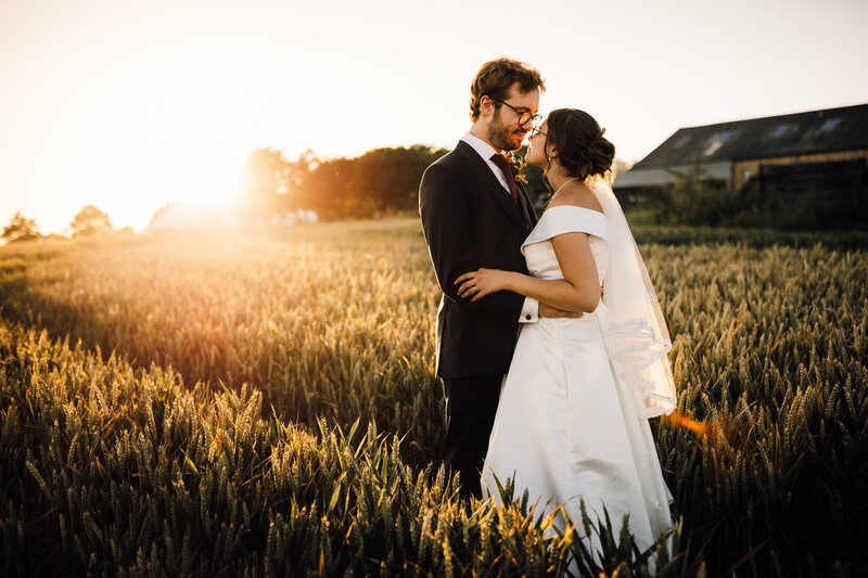 Bride and Groom portrait in garden field at sunset