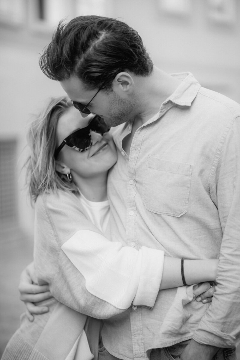 With a happy smile on their faces, this couple stands in a close embrace. Couple Photos Karin Busch L.A.