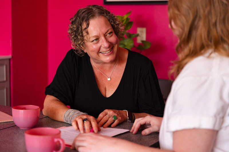 Cassie smiles while working with a client, representing her joy in working with those seeking a cannabis law attorney. 