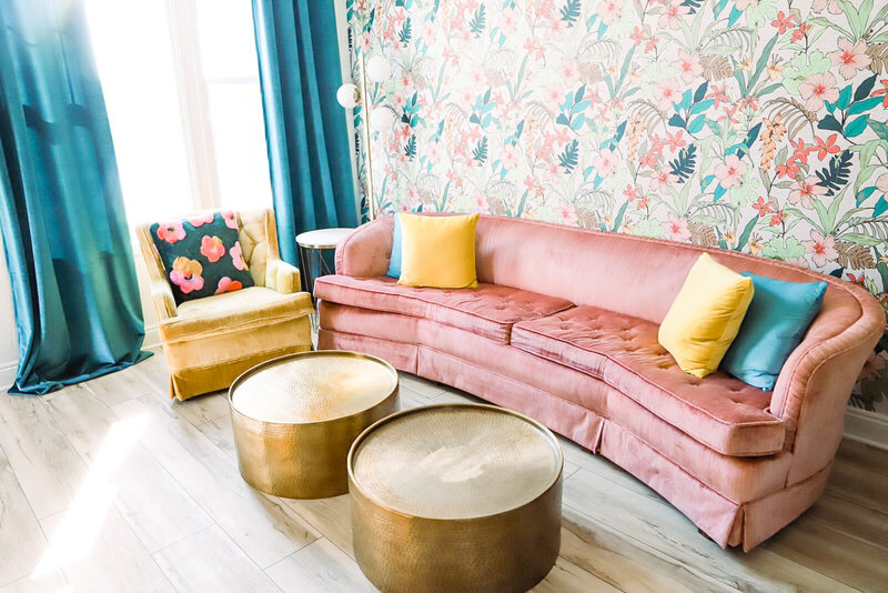 vintage living room with pink sofa and colorful wallpaper