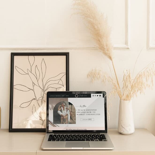 Laptop displaying custom website design with title ‘Every design starts with a story’ by Rachelle Deem