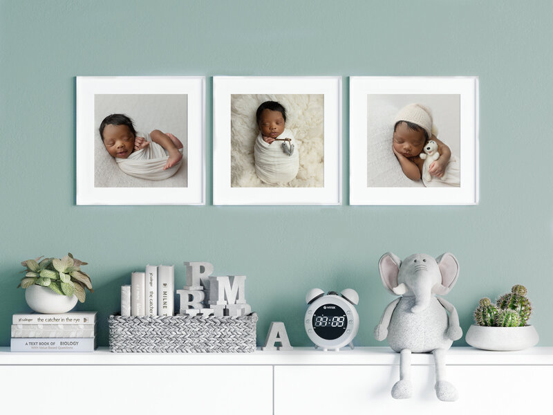 Framed fine art photography of newborn baby oin three images hangs on a nursery wall