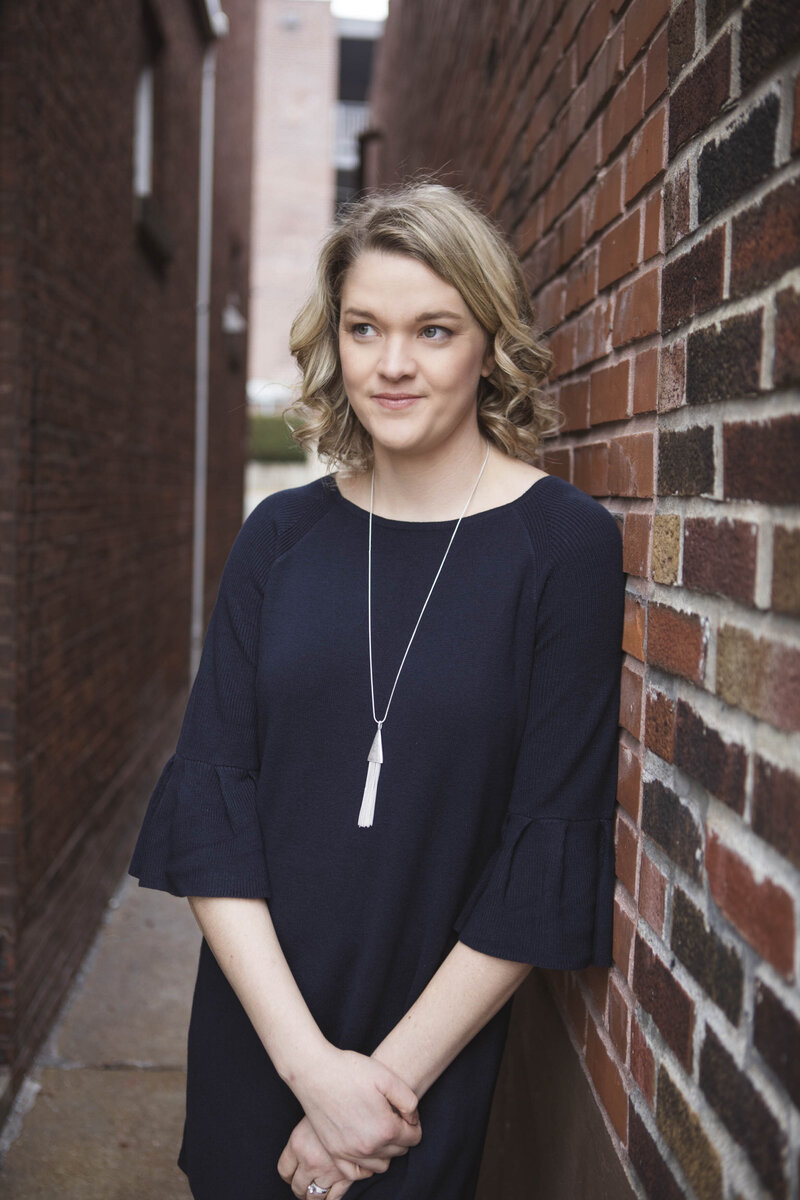 Laura leaning against wall