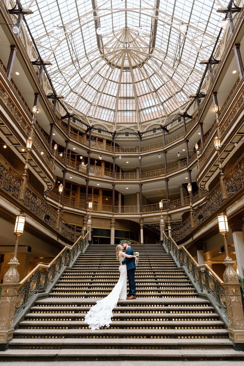 Bride and groom on the steps of the Arcade in Cleveland.