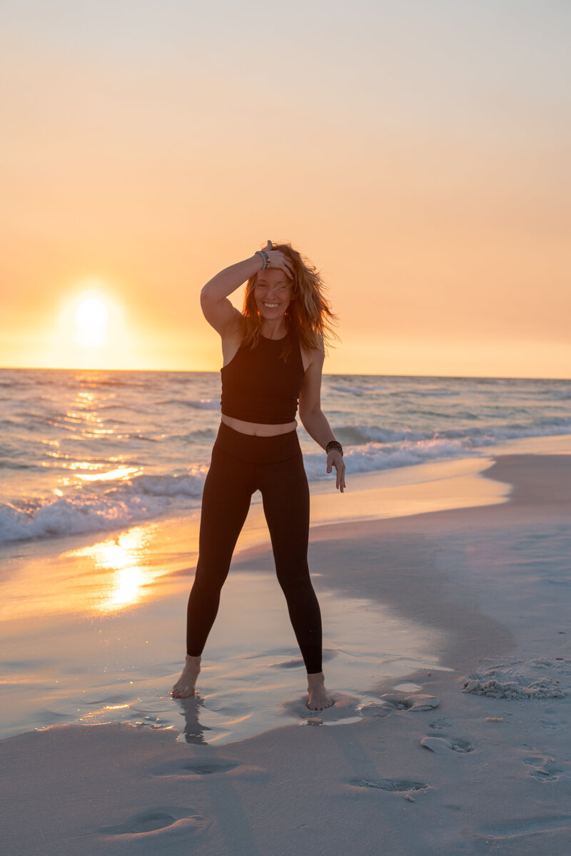 Stephanie standing on the beach at sunset 