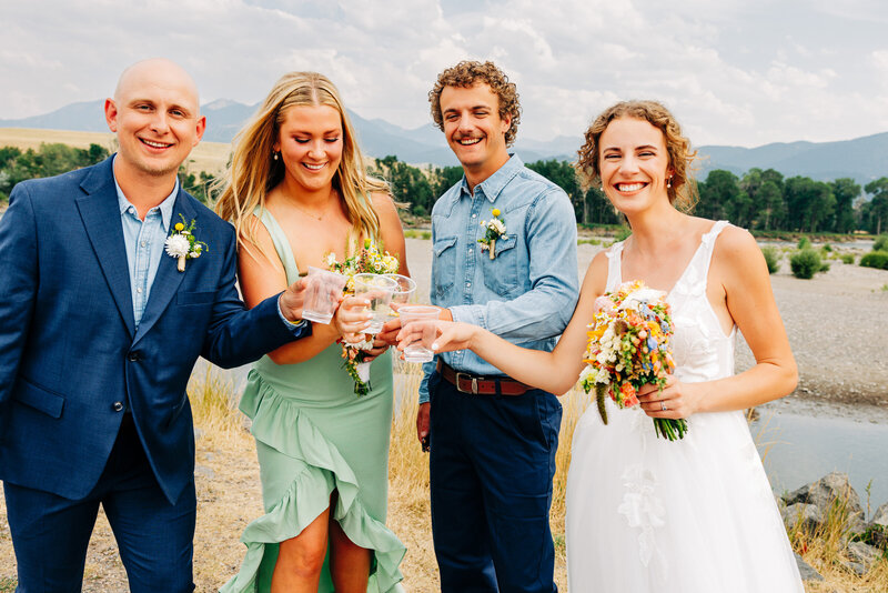 Bride and groom toasting with siblings at Miles Park Band Shell in Livingston, MT