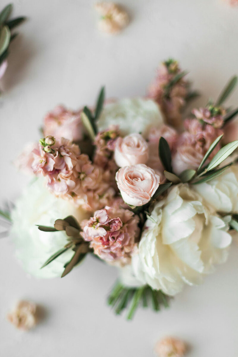 Soft, romantic bouquet of blush and white flowers with delicate greenery