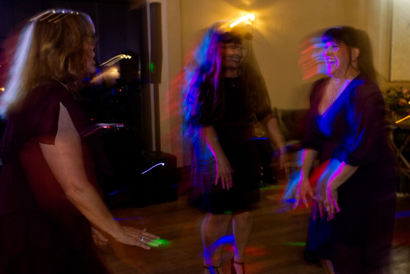 Three women dancing at wedding