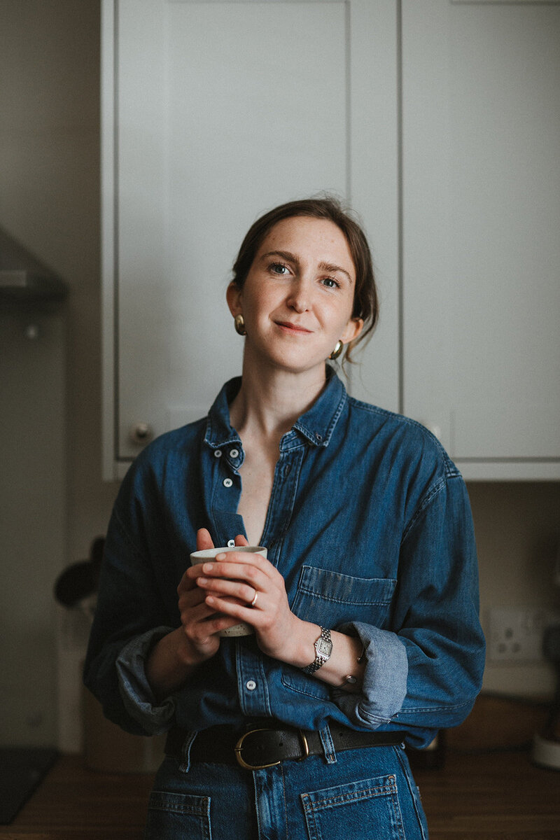 Smiling business coach and mentor hold a cup of coffee