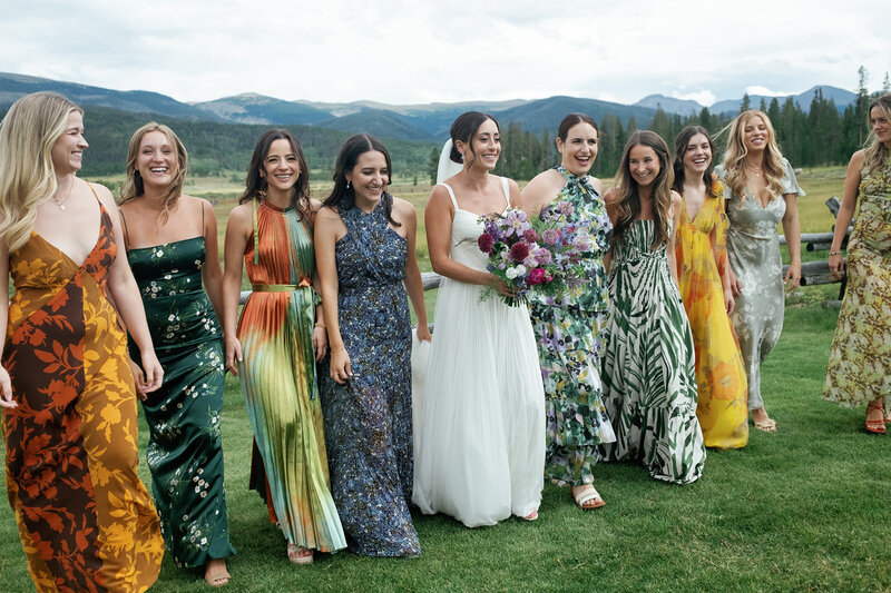 wedding bridal party walking in the mountain meadow at Devil's Thumb Ranch with Jenna Wren Photography