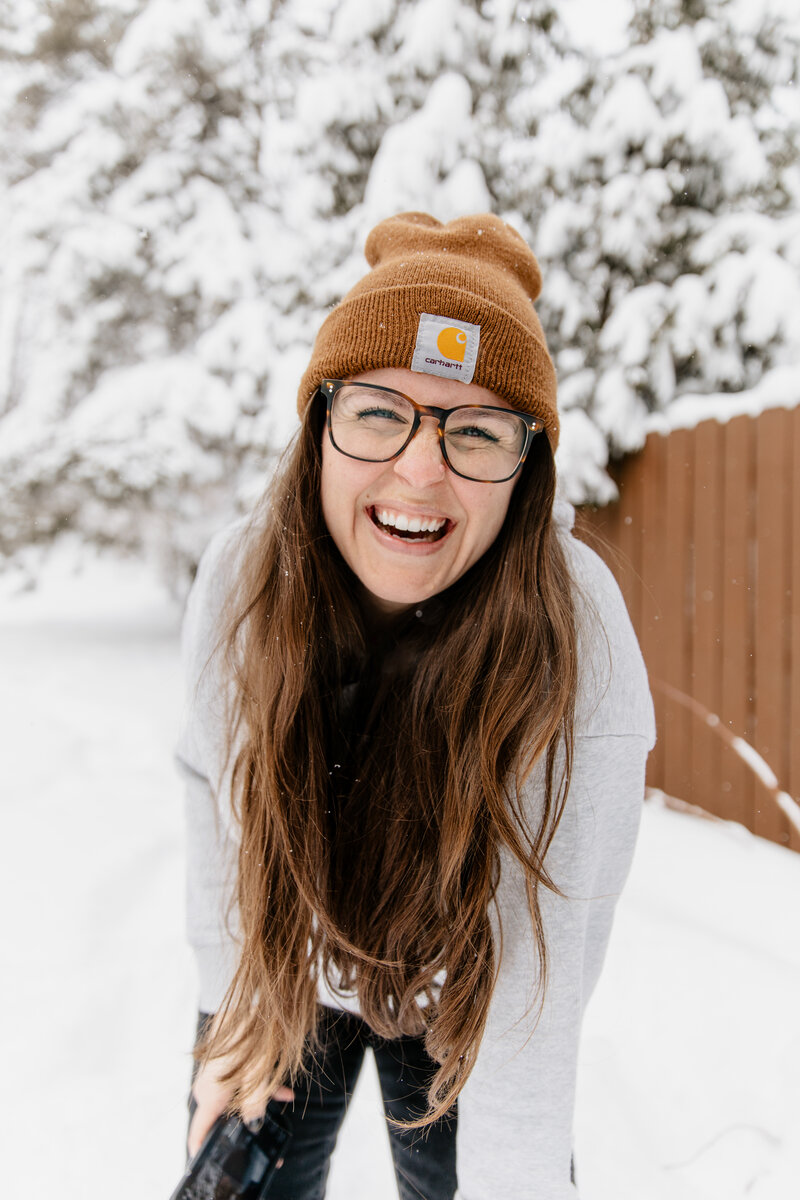 Amidst the serene winter landscape, discover Morgan, one of the finest wedding photographers in Duluth, MN. Wrapped in a cozy brown Carhartt hat, she radiates warmth and joy, ready to capture the magic of your special day in every snowy scene. Choose Morgan Elizabeth Photography to transform your winter moments into cherished memories. Book your session today!