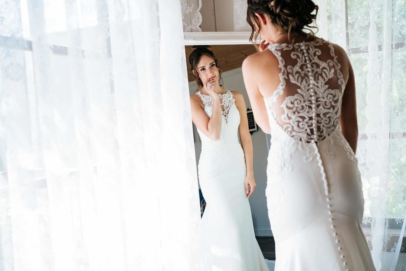 Bride is looking into the mirror