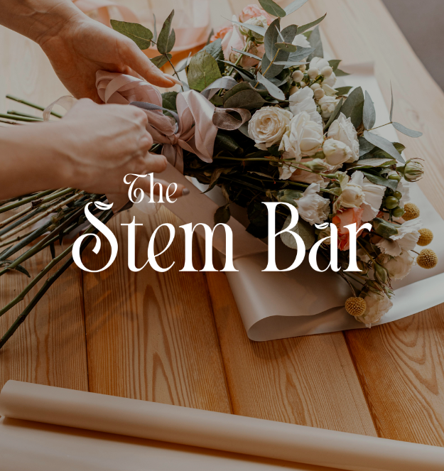 A women making a bouquet of flowers with an elegant logo for The Stem Bar overlayed on the image