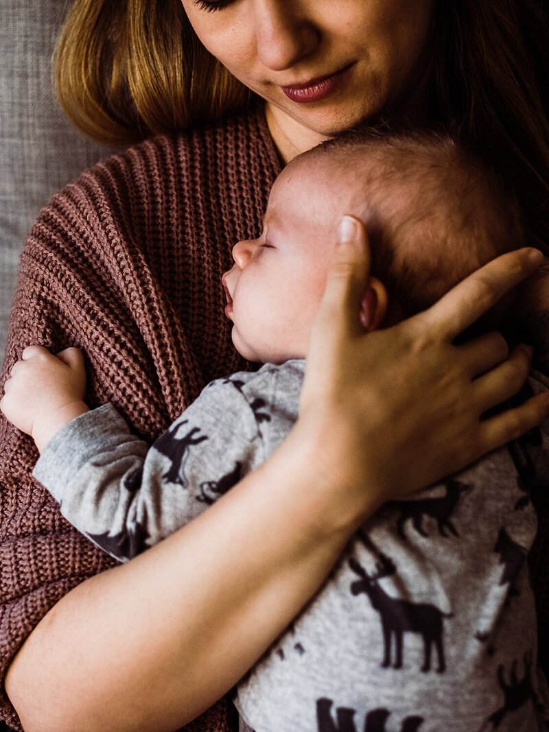 mom holding sleeping baby, newborn session at home