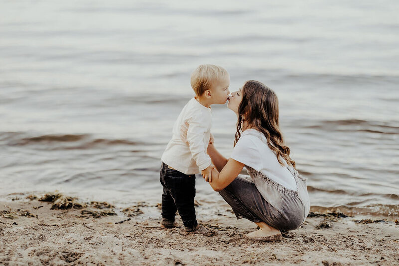 Big sister kissing baby brother