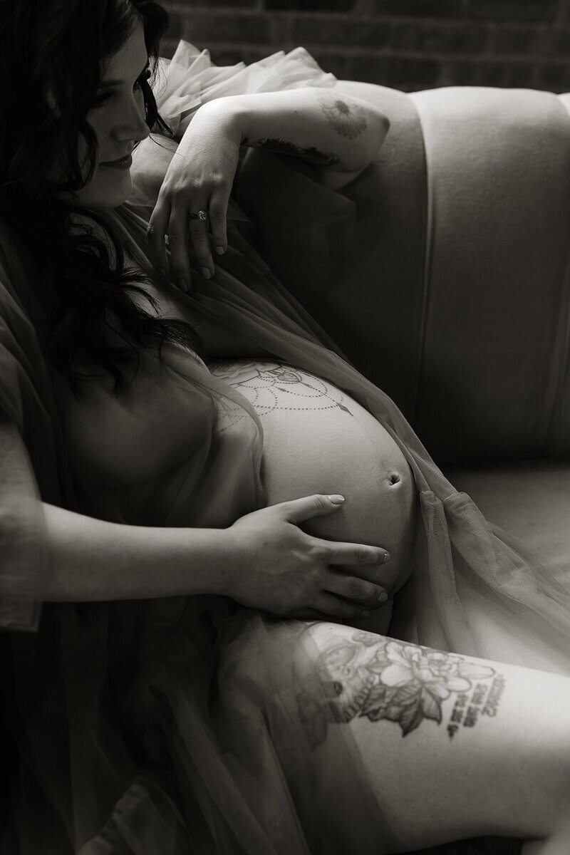 Black and white maternity portrait in studio by a maternity photographer in Michigan