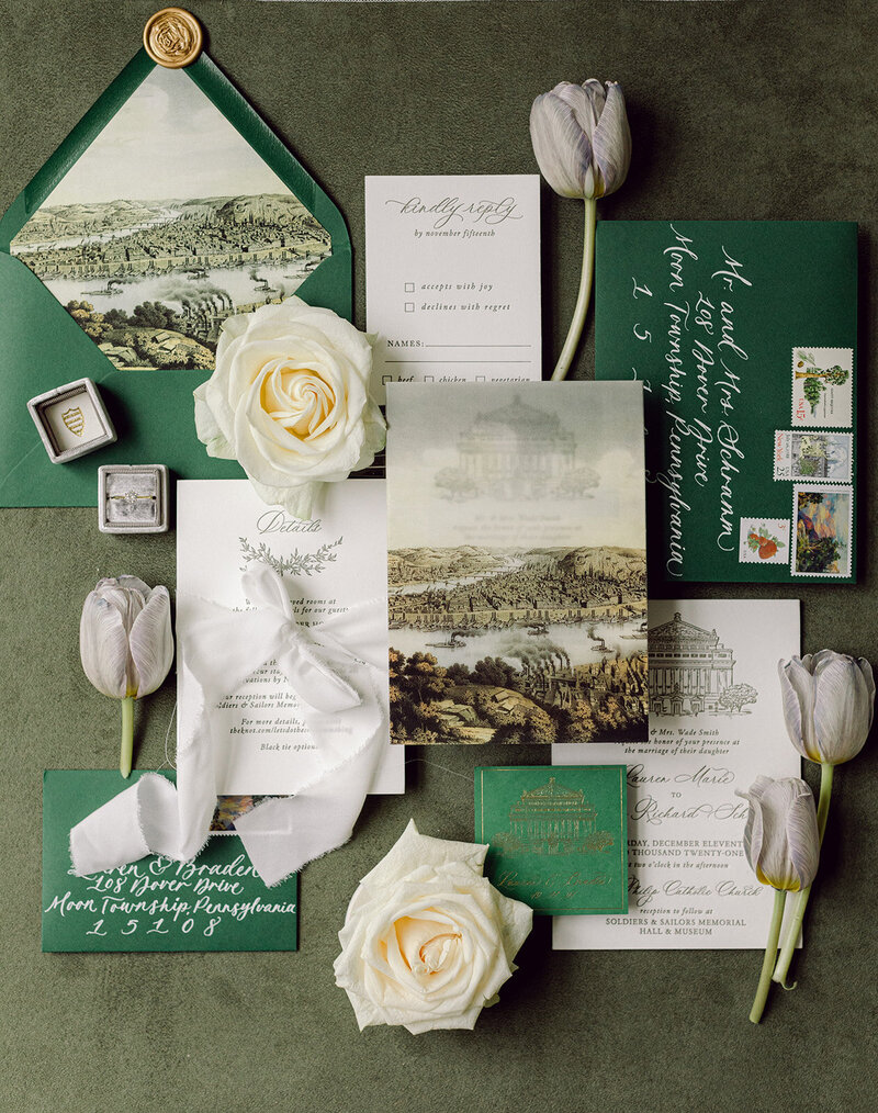 Olive green suede styling mat with wedding details and invitation suite