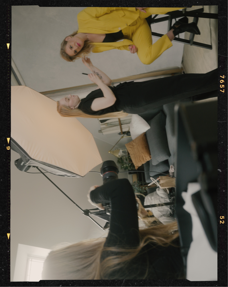 Behind the scenes photo of an empowering portrait session of a woman in a yellow suit in Helena Kristianssons Stockholm Studio