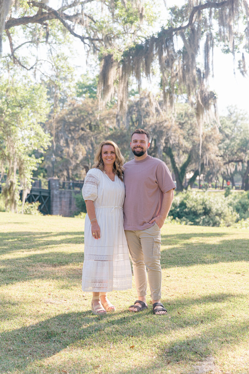 Mom and adult son smile for Palmetto Bluff Photographer during family portrait session with Lamp and Light Photography.