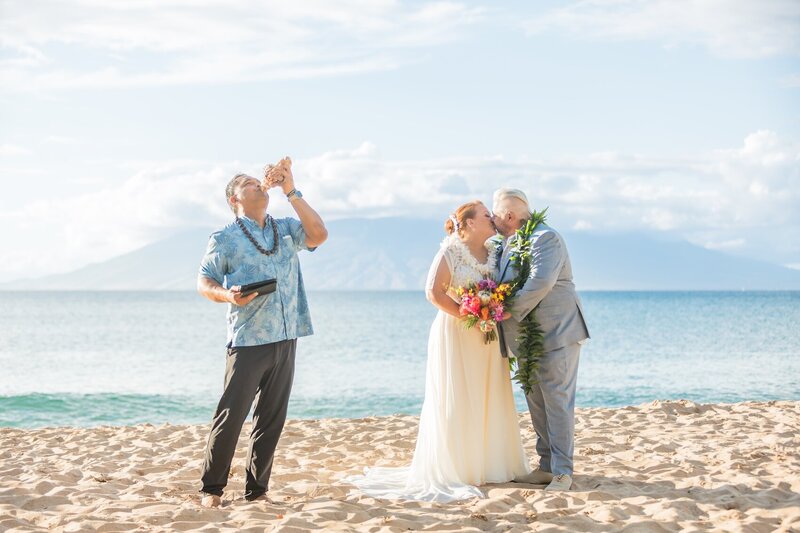 Oahu Wedding Officiant Ellsworth Simeona blowing the conch during a ceremony