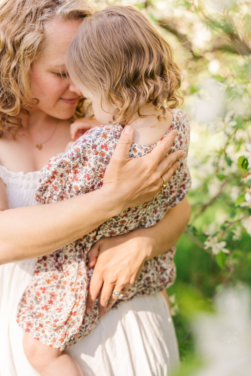 a mother hugs her toddler