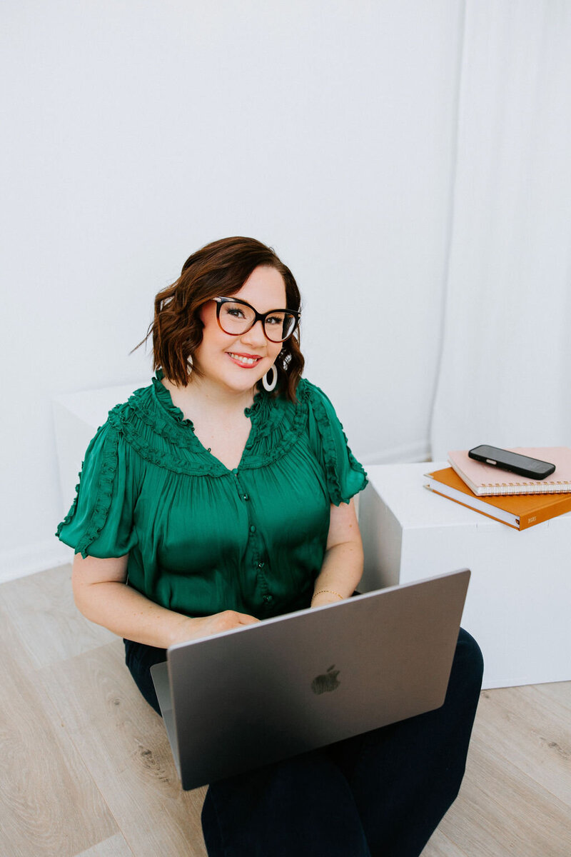 Copywriter Sara Gillis sitting outside with a beverage