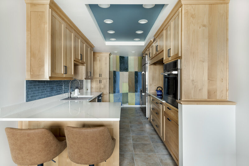 outdated kitchen with white cabinets and wood floors