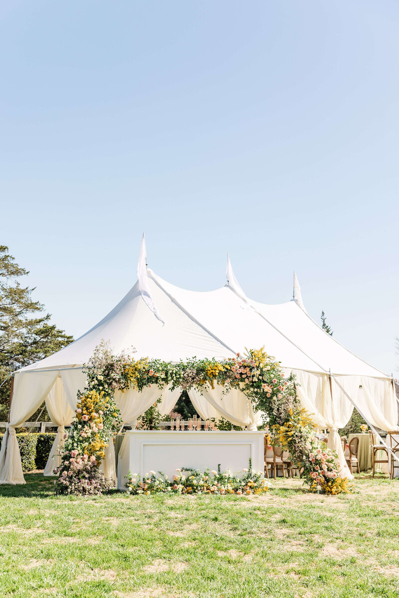 White tent wedding with stunning floral archway at the entrance Milwaukee, Wisconsin.
