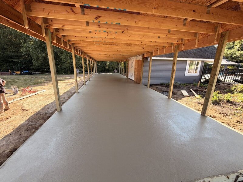 New concrete floor under the trusses of an open pole building in Middlebury, IN