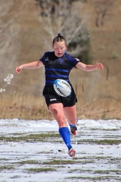 Women's Team Action Shot in Snow - Zoomie Rugby