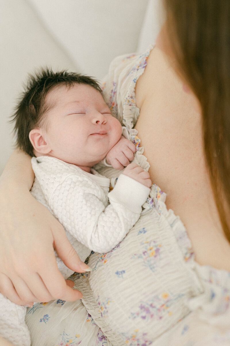 newborn baby sleeping in womens arms knoxville tennessee newborn photographer
