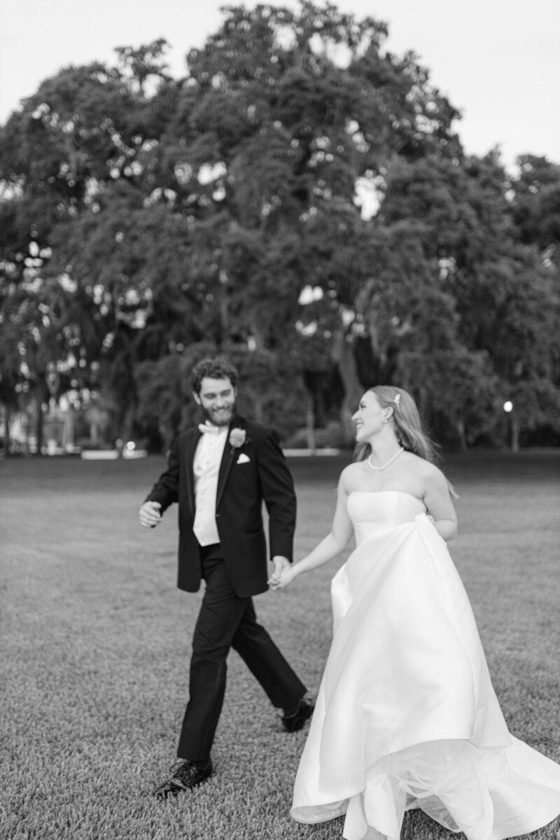 blurred image of bride and groom running