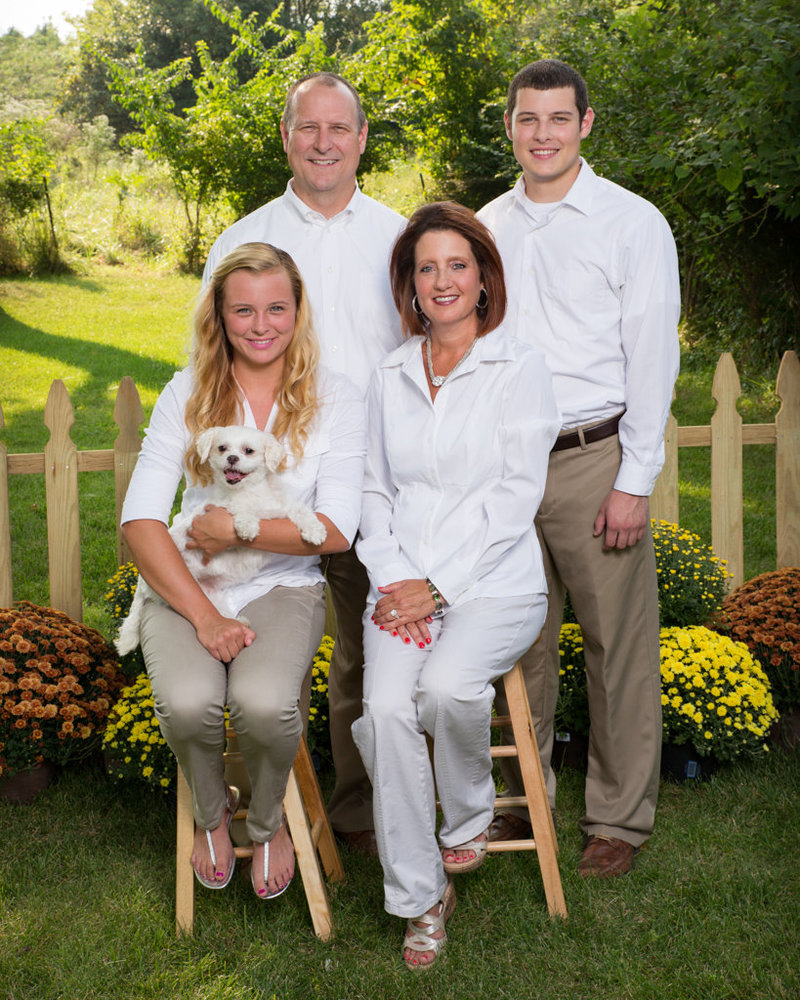 Family of Four Posing for Picture with Dog