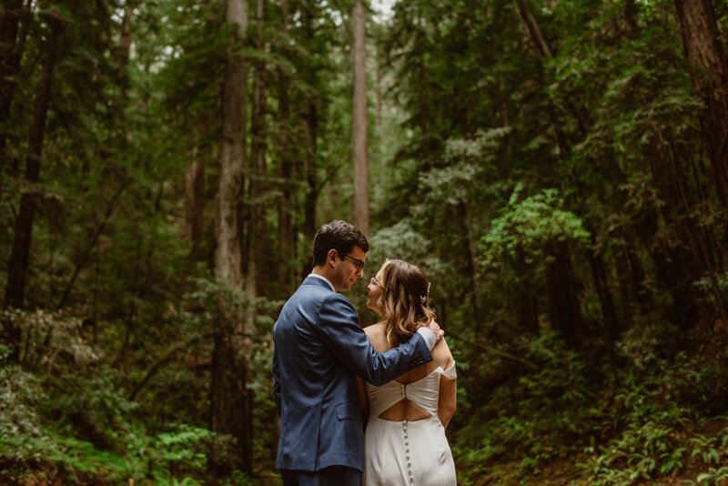 Bride and groom sharing a quiet moment in the forest during their all-day Northern California redwood elopement