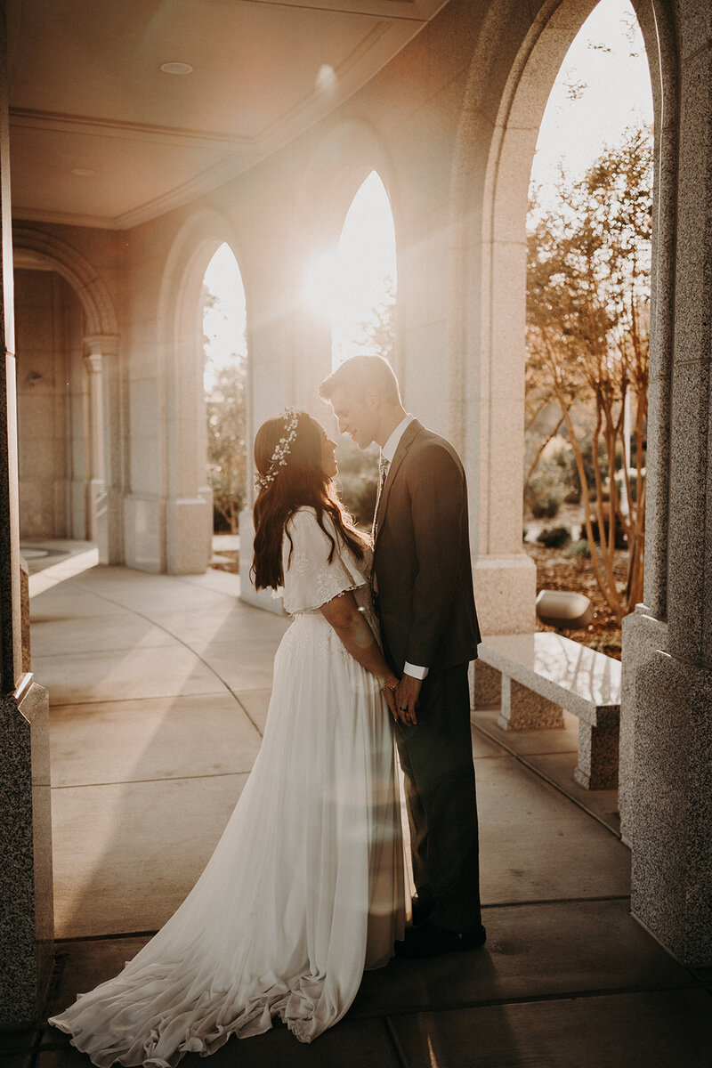 Bride & Groom holding hands as they look at their officiant during their wedding ceremony