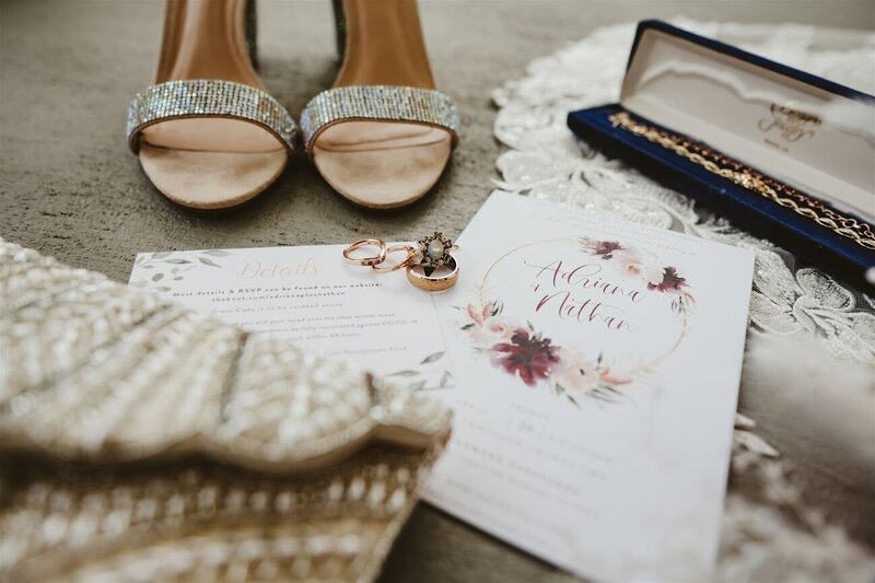 wedding shoes, rings, and invitation