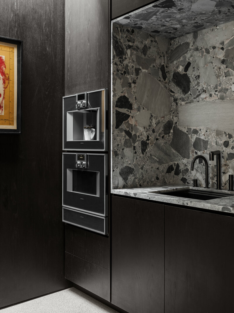 Modern kitchen with marble counters and wood cabinets designed by Palm Springs architect.