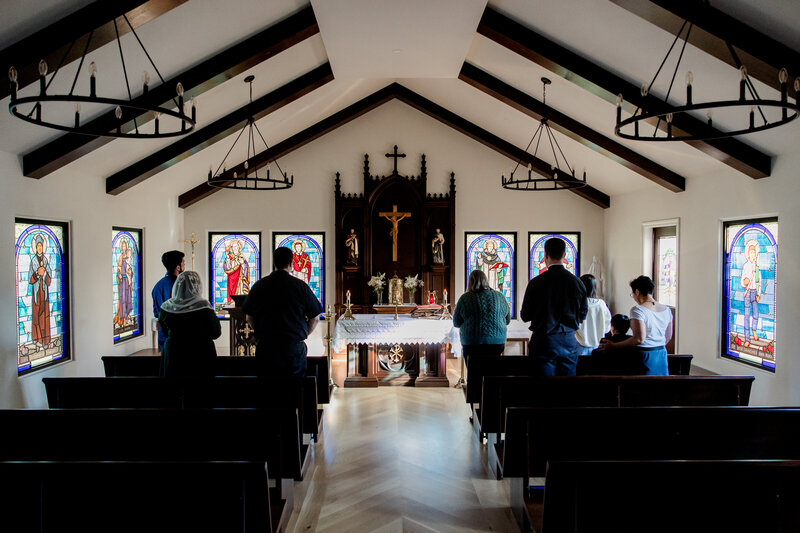 people attending a ceremony in a Catholic church